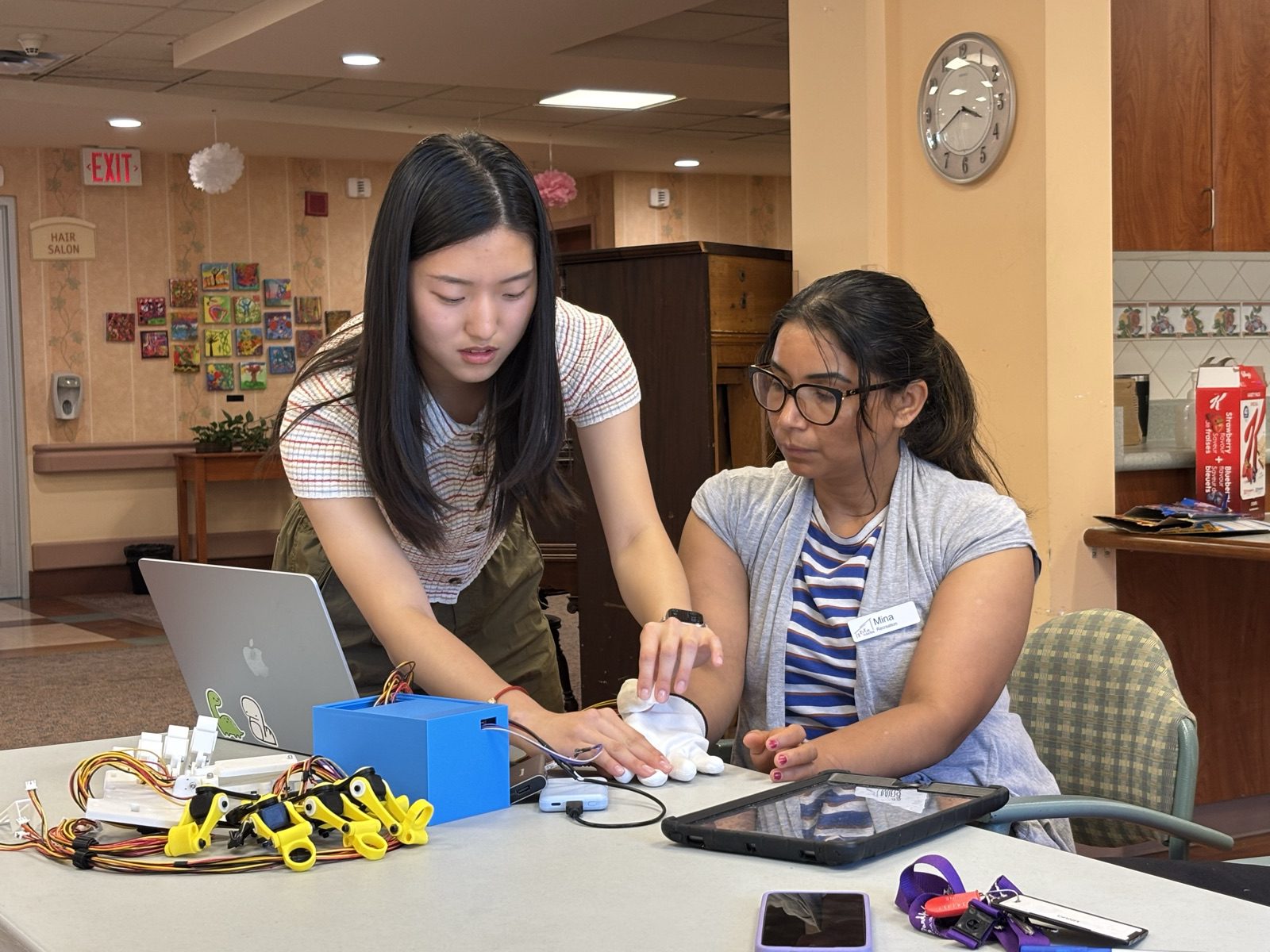 Yanzi walking a senior-center staff member through the Ripple device and web app